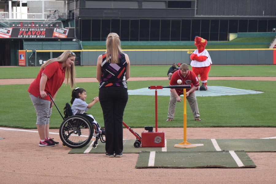 Child hitting the ball with the Batter Up machine at Great American Ballpark