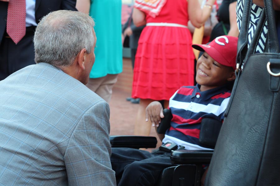 Thom Brennaman greeting one of the smiling children