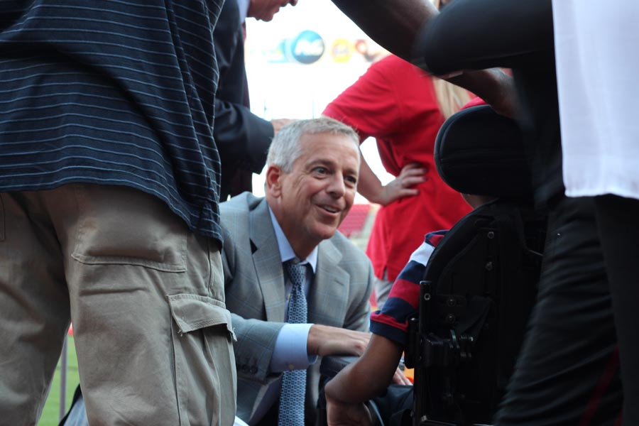 Thom Brennaman greeting one of the children at May We Help Leadership Gala 2016